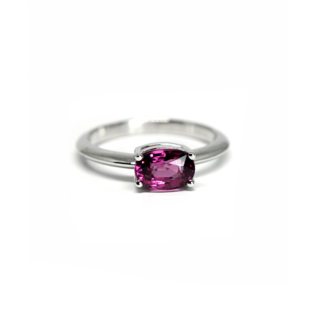 White gold solitaire engagement ring with a raspberry garnet. Stack it easily with any wedding band or wear it alone. Find more bridal jewelry and precious jewels at Ruby Mardi in Montreal.