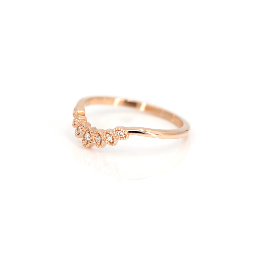 side view of emily gill wedding band design rose gold bridal ring specialist in montreal best jeweler in canada on pink background