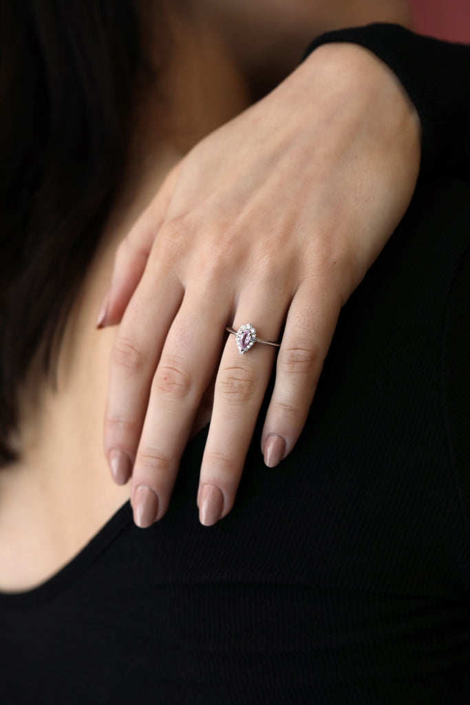 girl with a black shirt wearing a pear shape pink sapphire diamond engagement ring custom made by bridal jewellery designer ruby mardi