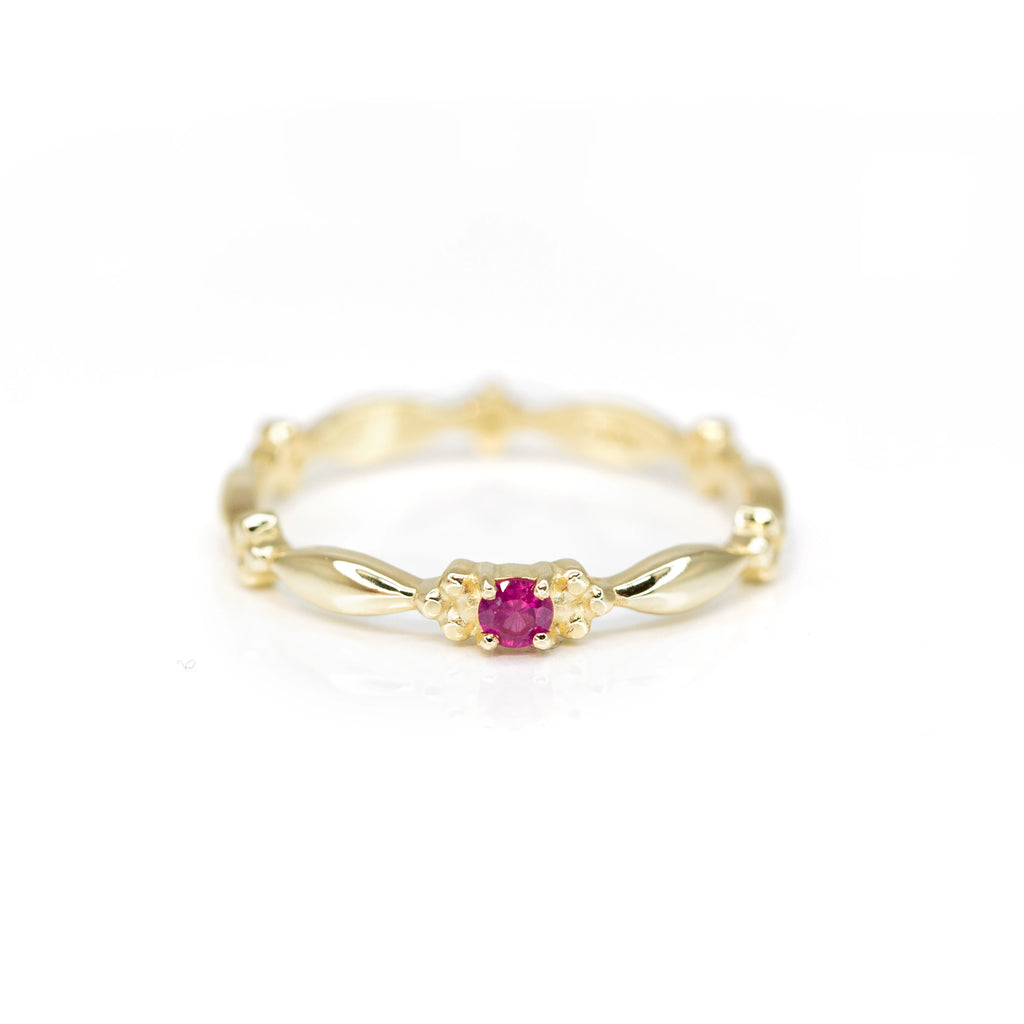 yellow gold dainty engagement ring custom made bridal ring made in montreal by ruby mardi on a pink background