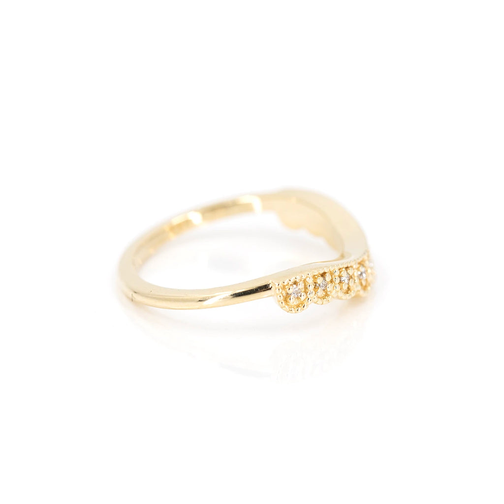 side view of yellow gold wedding band made by Emily Gill fine bridal jewelry designer at boutique ruby mardi jeweler in montreal on white background