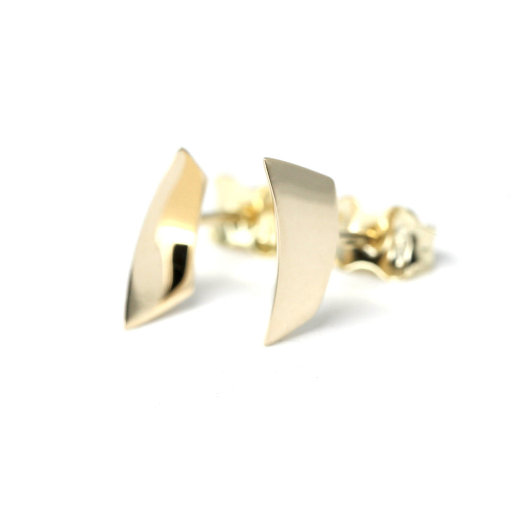 Sculptural yellow gold stud earrings with a bold, curved design. Handmade in Montreal by Bena Jewelry, an independent Canadian designer. These unisex earrings are available at Ruby Mardi, a fine jewelry boutique in Montreal.