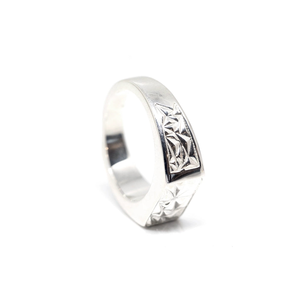 Side view of Bena Jewelry’s men silver signet ring handmade in Montreal, seen on a white background. Bold designer artisan gender neutral jewellery available in Little Italy or online, at Ruby Mardi.