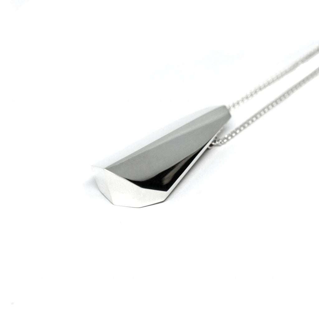 side view of silver unisex bold pendant made in montreal at the best jewelry store boutique ruby mardi by bena on white background
