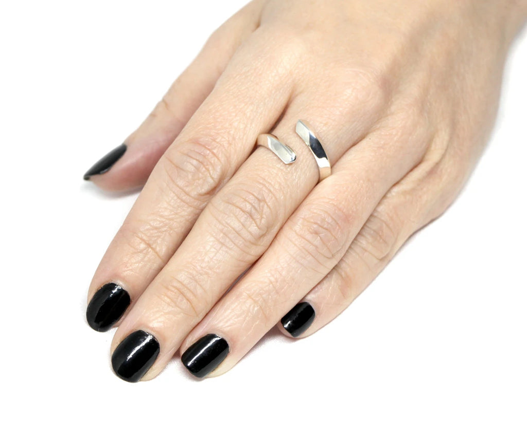 A lady’s hand wears a simple yet beautiful designer silver sterling ring. Find more designer everyday jewelry and high end jewelry at Ruby Mardi, the only fine jewelry gallery in Montreal. 