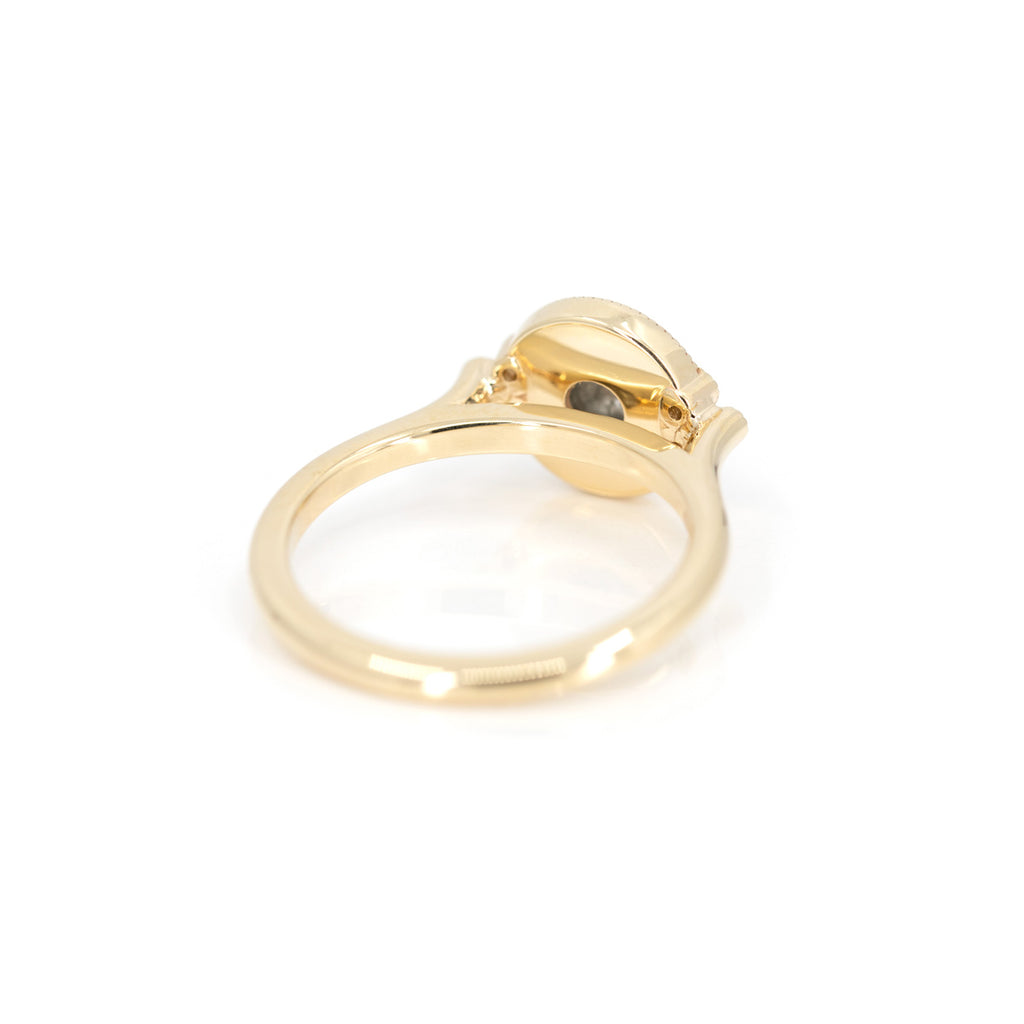 back view of yellow gold custom made designer engagement ring in yellow gold made by emily gill best jeweler in montreal boutique ruby mardi on white background