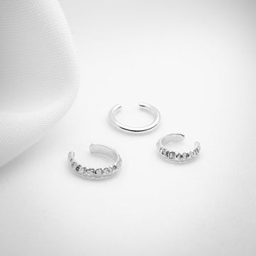 Three ear cuffs in sterling silver shown on a white background, one slick and 2 with texture. Handmade in Montreal by jewelry brand Véronique Roy JWLS