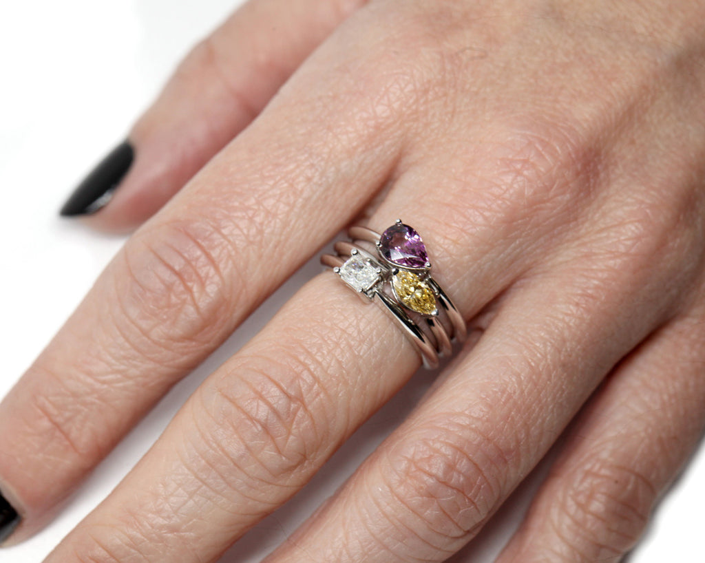 girl wearing stackable colored gemstone gold ring custom made in montreal by ruby mardi jeweller on a white background
