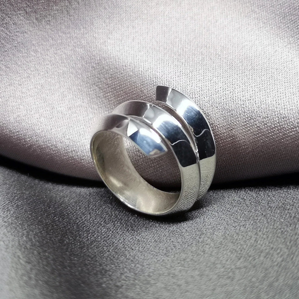 Fashion shot of sterling silver ring Embrace by designer Bena Jewelry. Modern designer jewelry available at Ruby Mardi, the only fine jewelry gallery in Montreal. Custom jewelry services also offered.