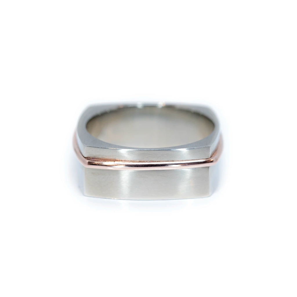 white gold men ring with a strip or rose gold custom made in montreal by jewelry designer Janine de Dorigny for ruby mardi best jeweler in canada on a white background