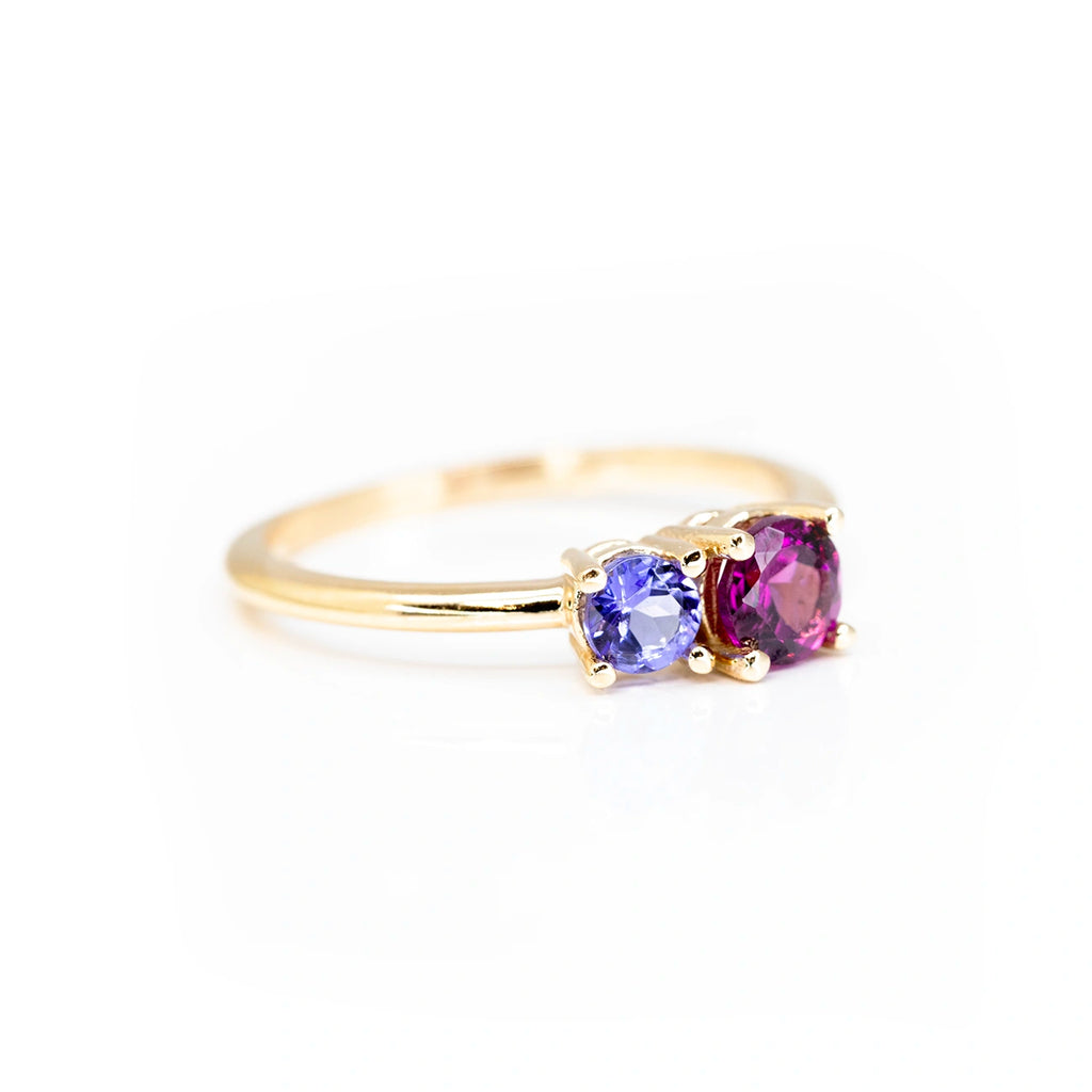 custom made round shape garnet and tanzanite gemstone in montreal by lico jewelry best jewelry store in quebec boutique ruby mardi on a white background