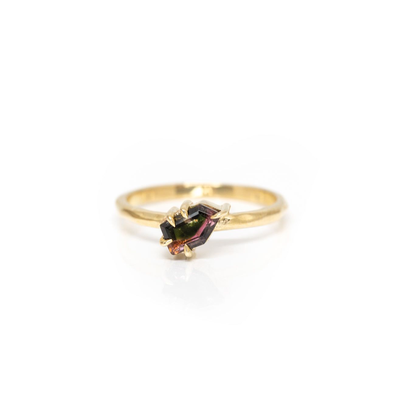 Close-up of a gold solitaire ring featuring a unique watermelon tourmaline in an organic claw setting. Designed by Nadia Werchola, available at Ruby Mardi, Montreal.


