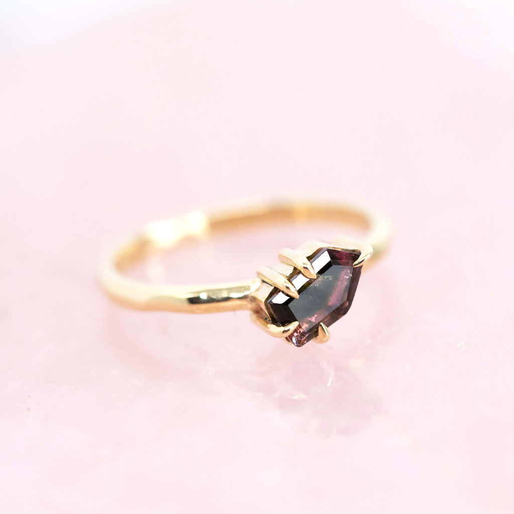 Original one of a kind yellow gold solitaire ring with a watermelon tourmaline showing mostly dark hues but also pink and green hues. Would make a beautiful engagement ring. Dainty and elegant. Seen here photographed on rose quartz.