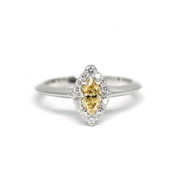 Stunning engagement ring featuring a big marquise yellow diamond with a round brilliant diamond halo, set in 14k white gold. A real treasure that was handmade in Montreal by jewelry brand Ruby Mardi.