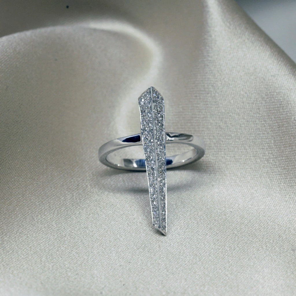 Peak ring with diamonds in white gold on a satin fabric photographed in close-up. Ready-to-wear fashion jewelry available online or at our concept store in Montreal's Little Italy, along with the work of other talented jewelry designers.
