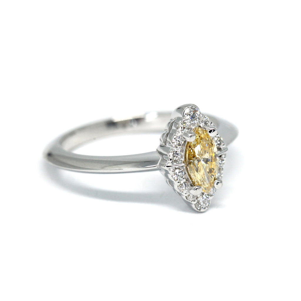 Yellow diamond and diamond halo : the perfect engagement ring. This jewel was handmade by Ruby Mardi in Montreal. Visit our fine jewelry store in Little Italy to see more designer jewels. 