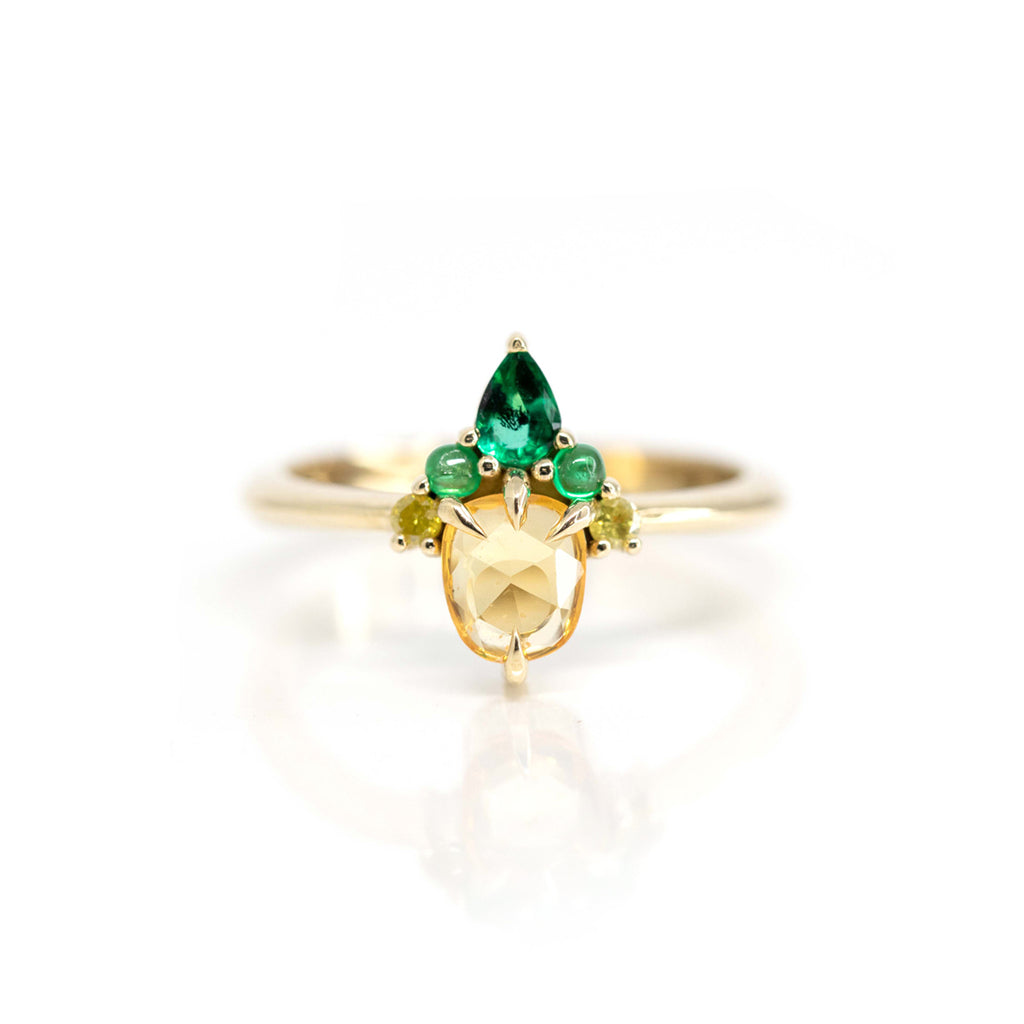 Stunning jewelry creation by Nadia Werchola in Toronto. A multi gemstone ring featuring a rose cut yellow sapphire, 2 emerald cabochons, 1 pear cut emerlad and 2 yellow diamonds. 