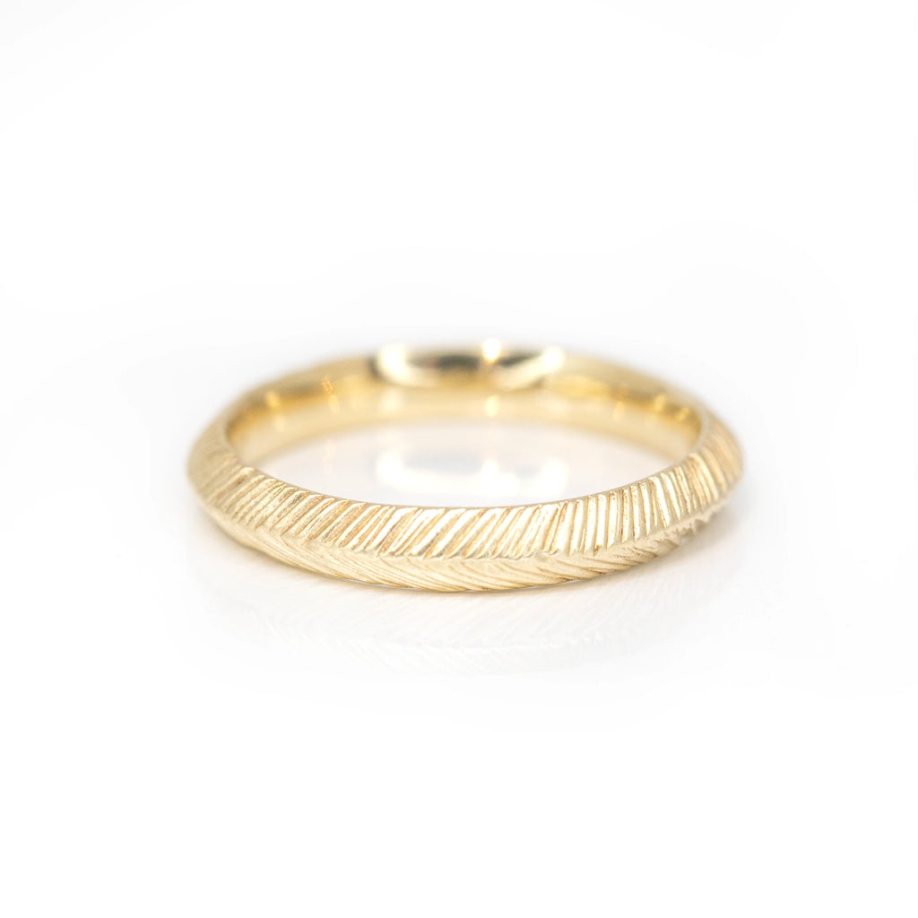 yellow gold textured artisan jewelry designer sheena from montreal yellow gold wedding band made in canada on a white background
