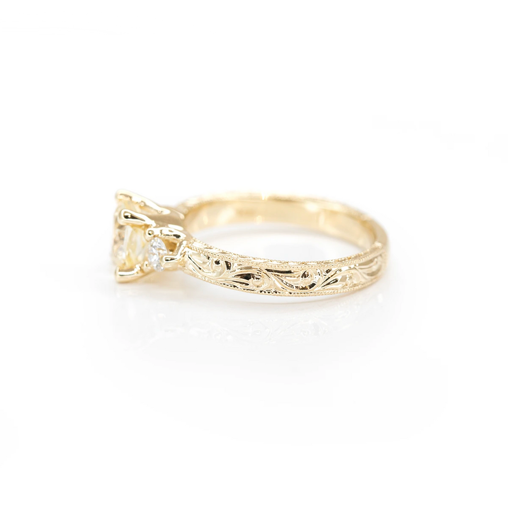 side view of yellow gold engraved bridal ring made by Deborah Lavery fine bridal jewlery designer in montreal at boutique ruby mardi on white background