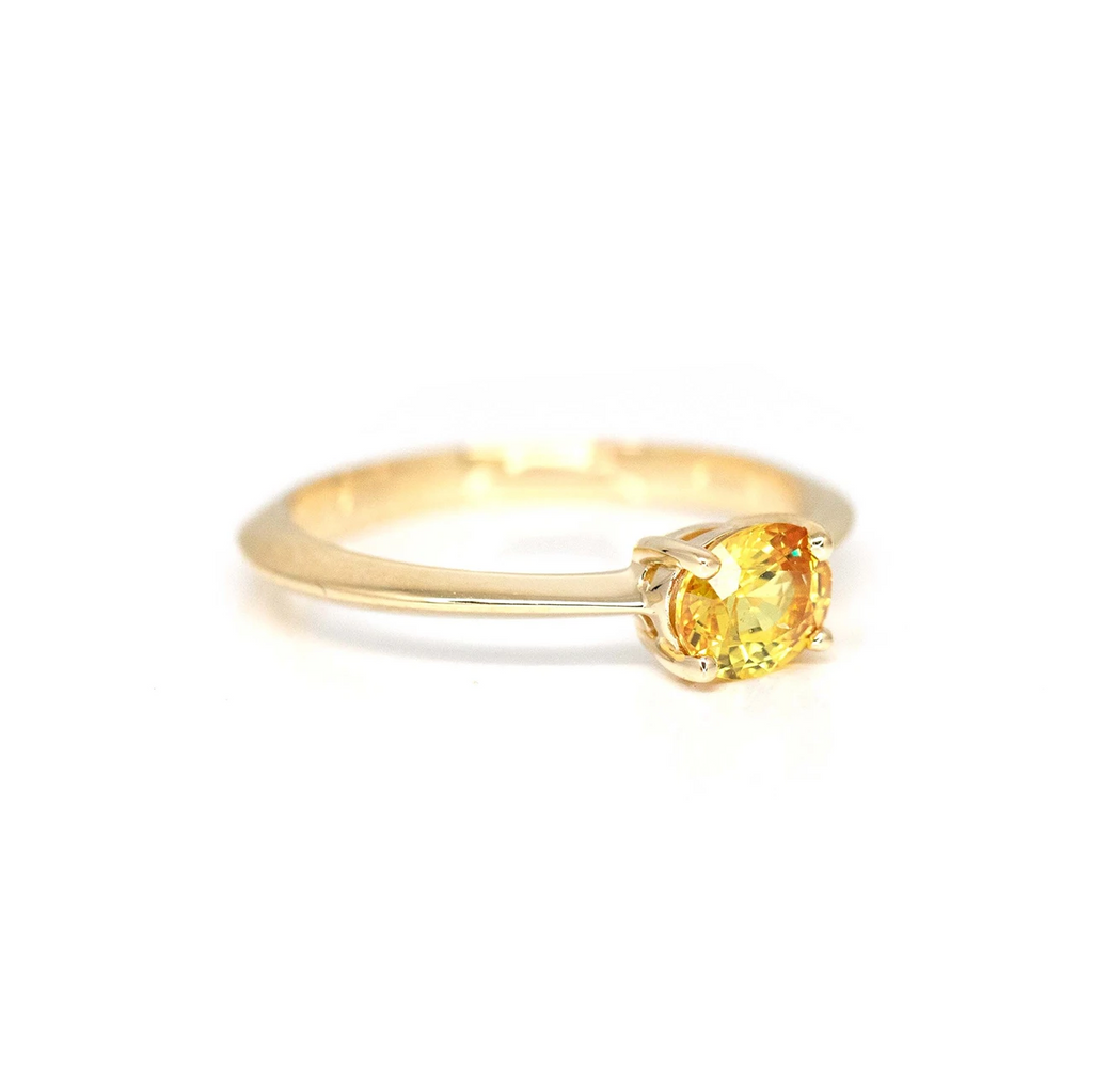 side view of yellow sapphire minimalist bridal engagement ring custom made in montreal best jewelry store boutique ruby mardi jeweler custom made bridal rings on a white background