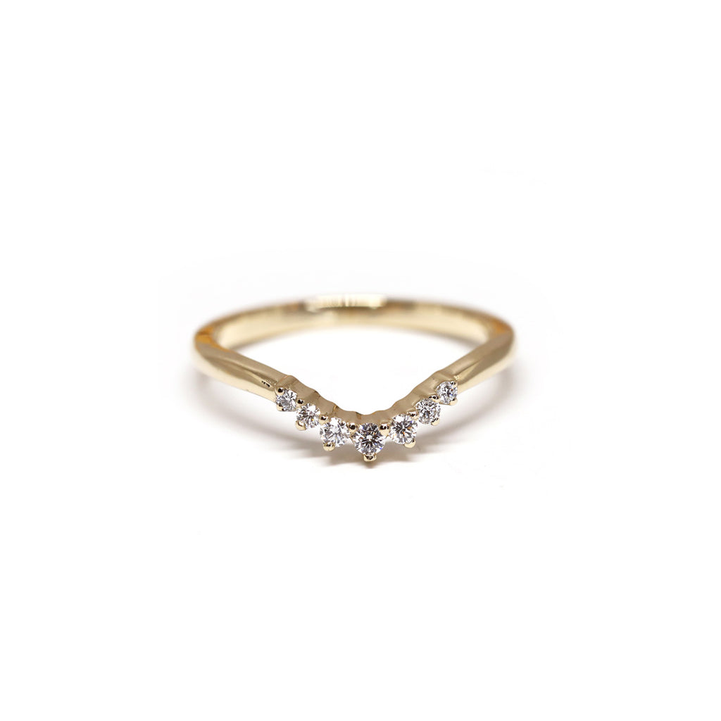 Beautiful delicate dainty yellow gold diamond band by Yuliya Chorna on a white background. Available at Ruby Mardi, a high end jewelry store showing the most talented Canadian jewellery designer. 