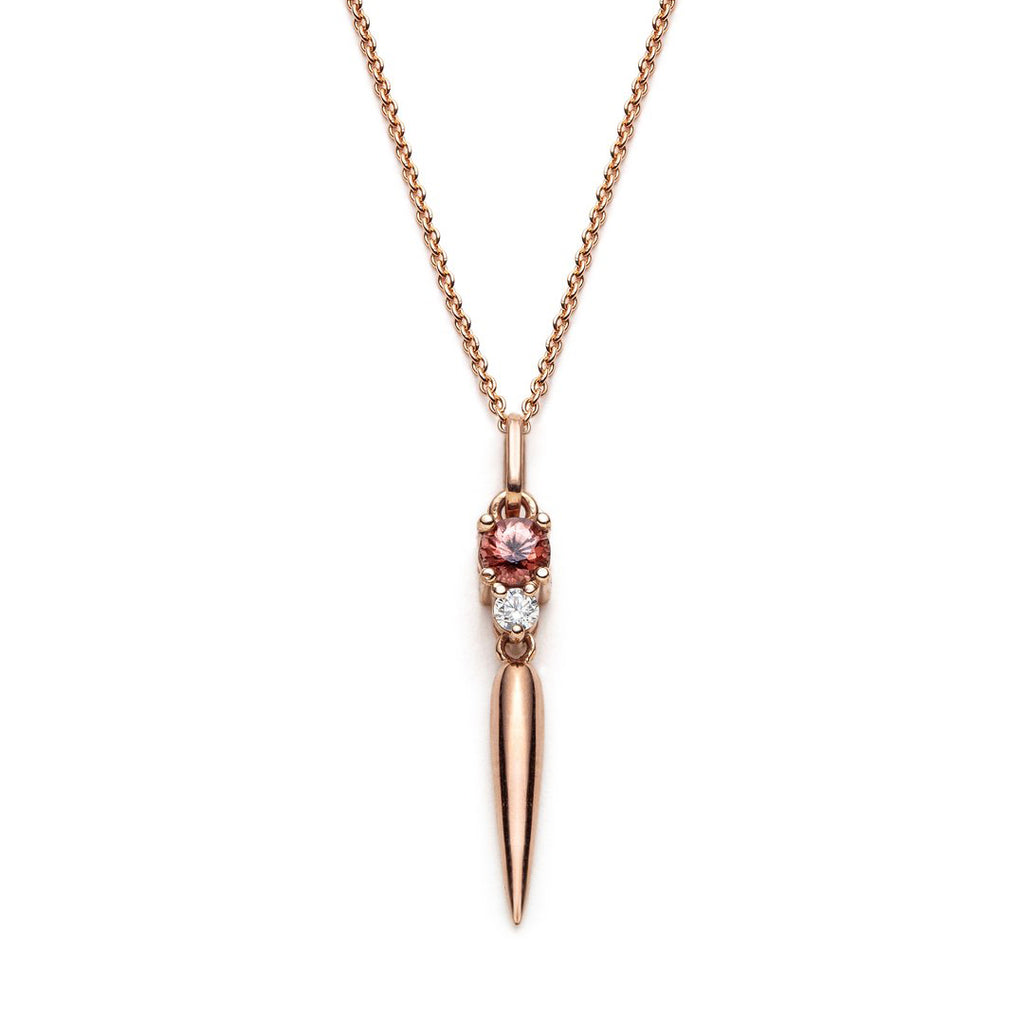 Rose gold dangling pendant by jewelry designer Justine Quintal featuring a stunning peach zircon and a small diamond accent, photographed on a white background. This piece of high end jewelry is available at fine jewelry store Ruby Mardi in Montreal.