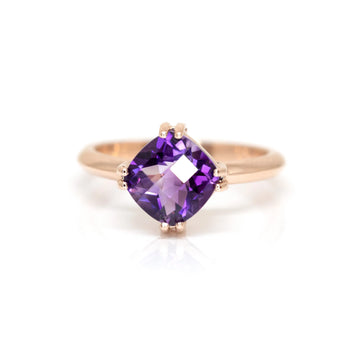 Cushion cut amethyst ring set in rose gold handmade in Montreal by designer Bena Jewelry seen on a white background.