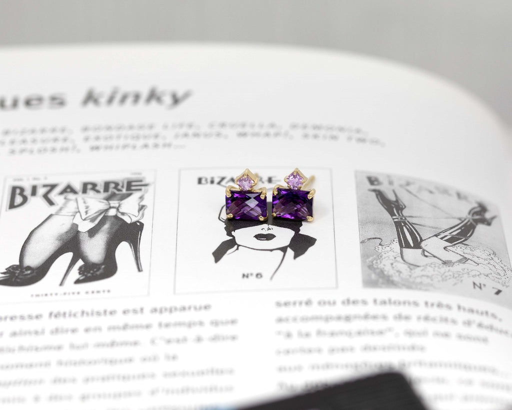 Pair of amethyst and pink sapphire gemstone stud earrings handmade in Montreal by Ruby Mardi, and photographed on a kinky vintage magazine.