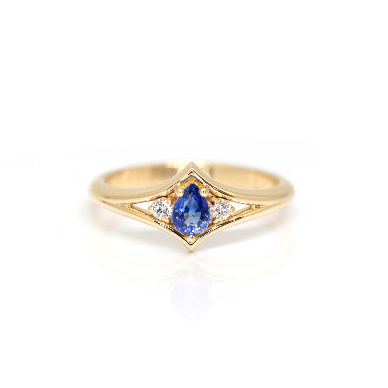 Pear shape yellow gold engagement ring with two diamonds custom made in Montreal by Bena Jewelry and photographed on a white background.