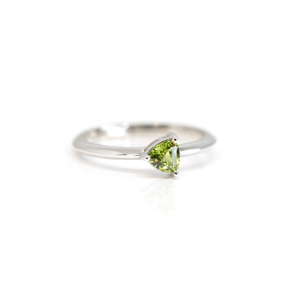 side view of green sapphire white gold custom made engagement ring minimalist design by the best montreal jewelry store boutique ruby mardi on a white backgound