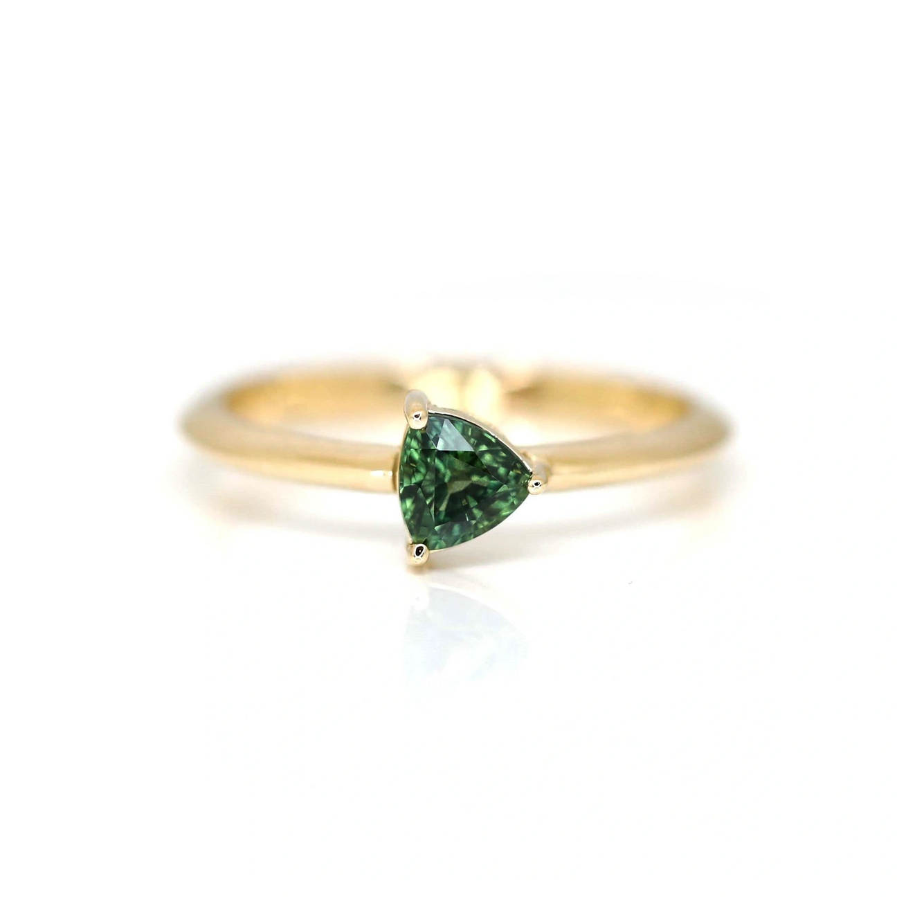 trillion shape green sapphire yellow gold custom made bridal engagement ring ruby mardi best jewelry designer in canada on a white background