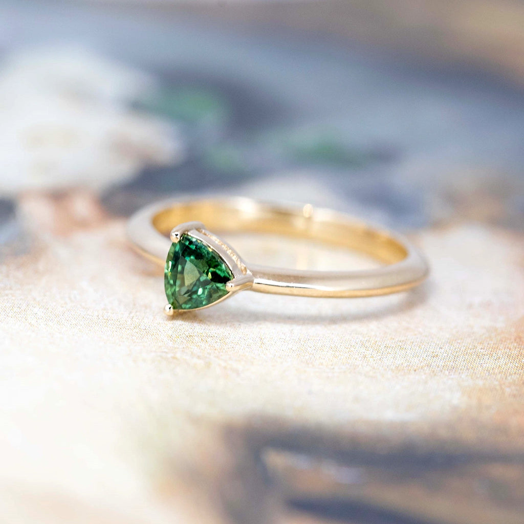 Engagement ring with deep green sapphire mounted on yellow gold, this minimalist ring is custom made in our Montreal workshop Ruby Mardi. This bridal jewelry is made with a natural gemstone for an elegant and timeless style.