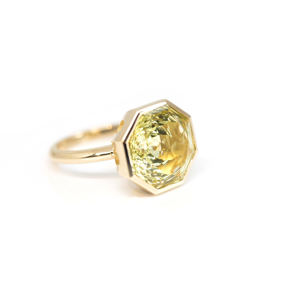 Side view of a custom made lemon quartz statement designer ring handmade and designed by Bena Jewelry, photographed on a white background.
