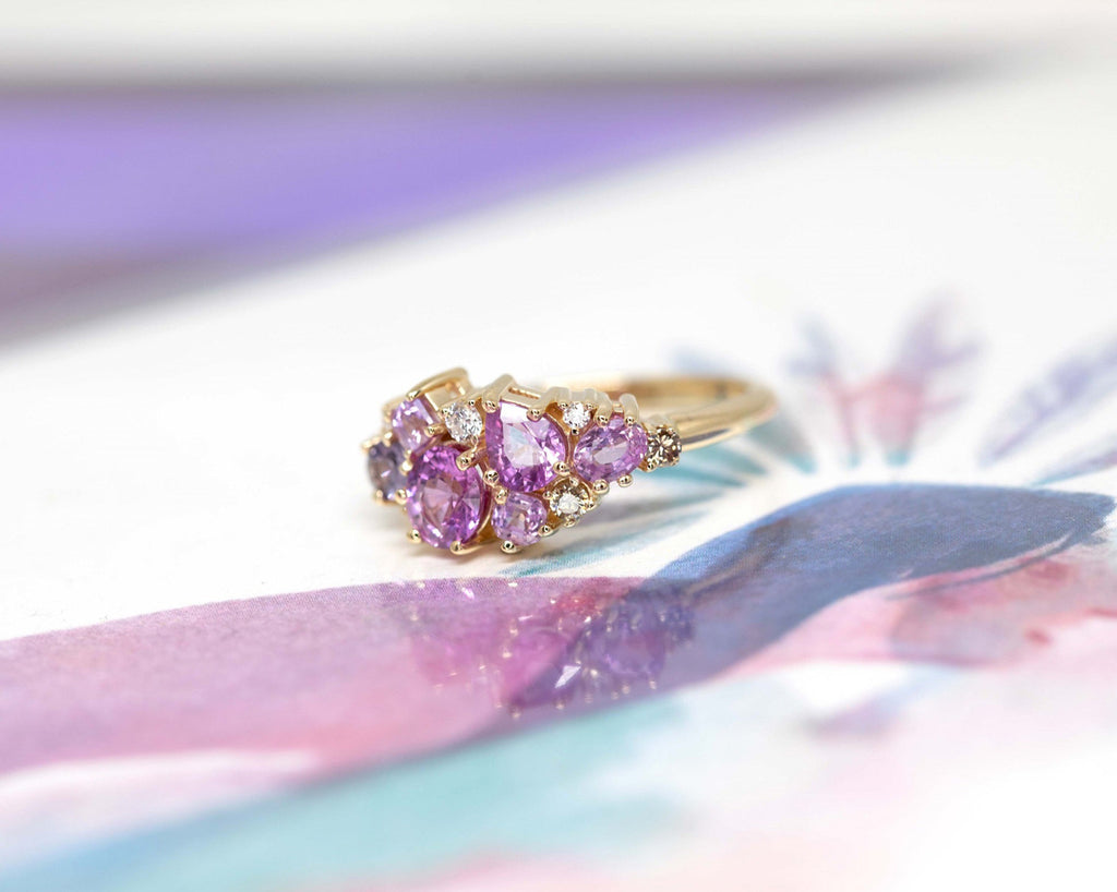 High end jewelry piece handmade by Ruby Mardi in Montreal, seen on a French illustration from Louise de Crozals. Our Avalanche ring features pink and violet sapphires, as well as round brilliant diamonds. A perfect engagement ring!