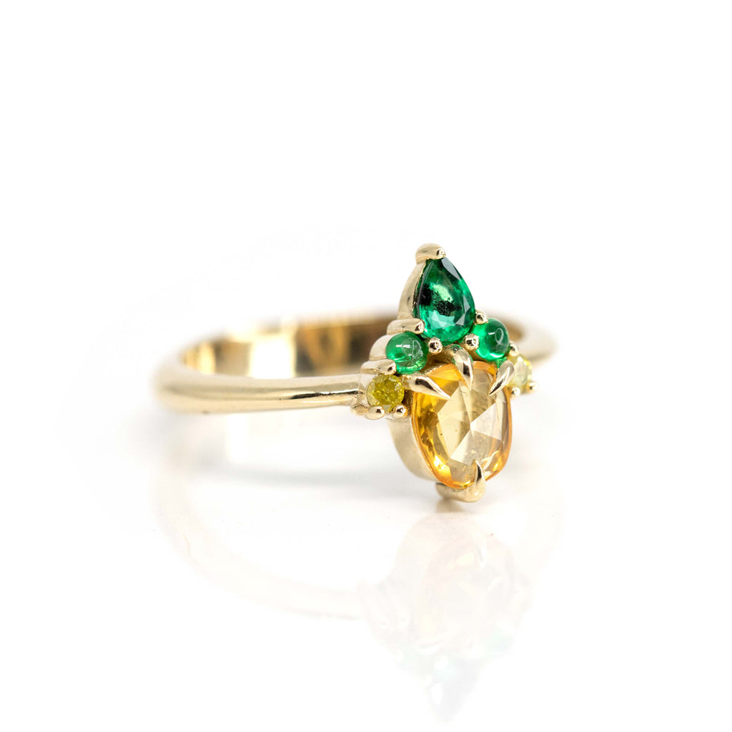 Side view, almost front view, of stunning colour gemstone ring by Nadia Werchola : yellow saphire, diamonds and emerald. FInd it at high end jewelry store Ruby Mardi in Montreal.